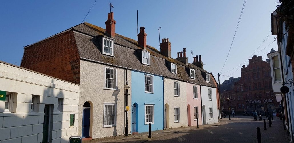 A row of colourful terraced buildings in various pastel colours